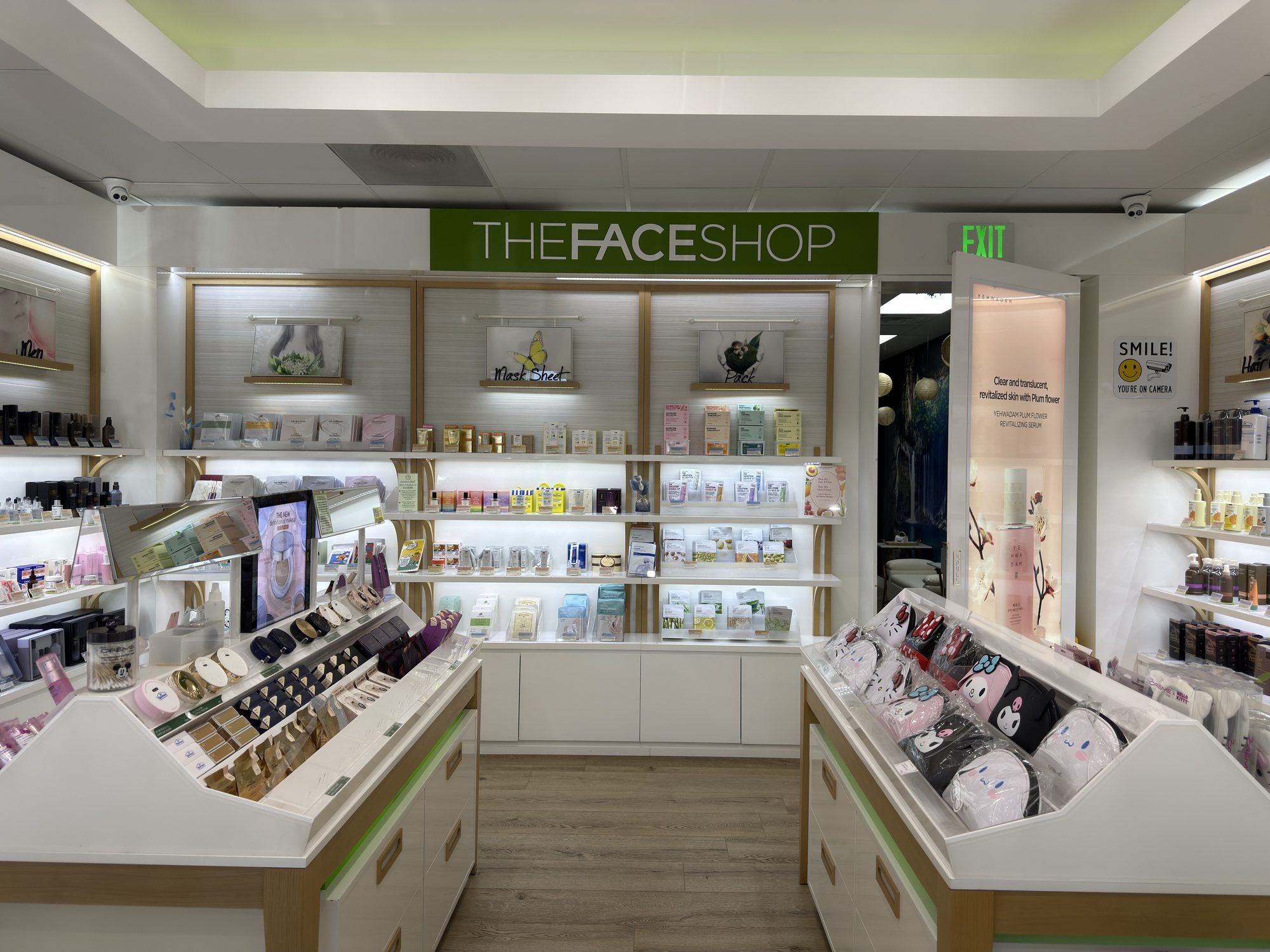 Backlit THEFACESHOP wall with product shelving