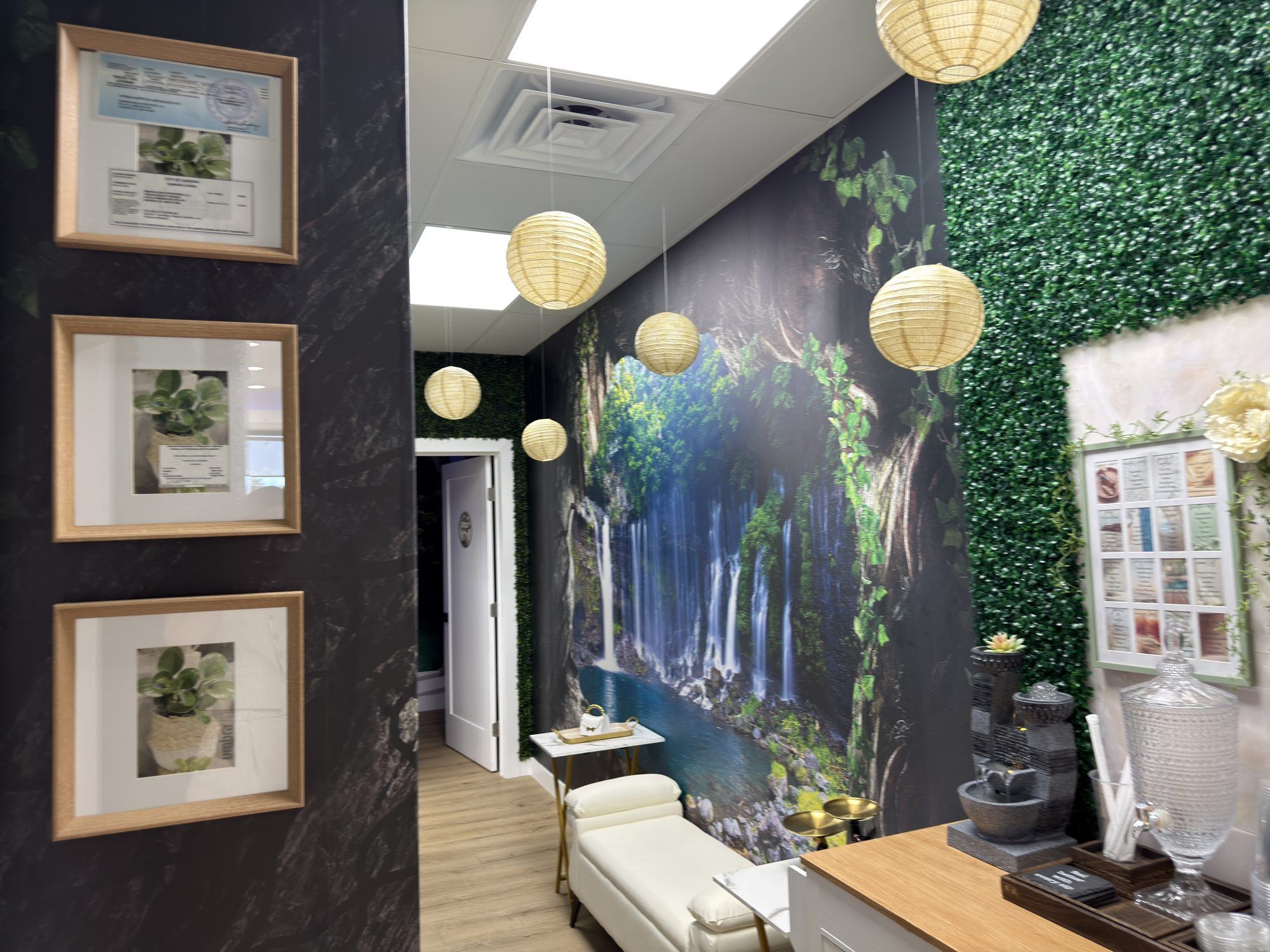 Corridor into the spa with a waterfall mural, paper lanterns and a bench